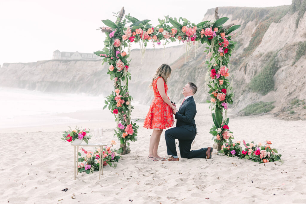 Bay Area wedding photographers capture man on one knee proposing to woman at Half Moon Bay
