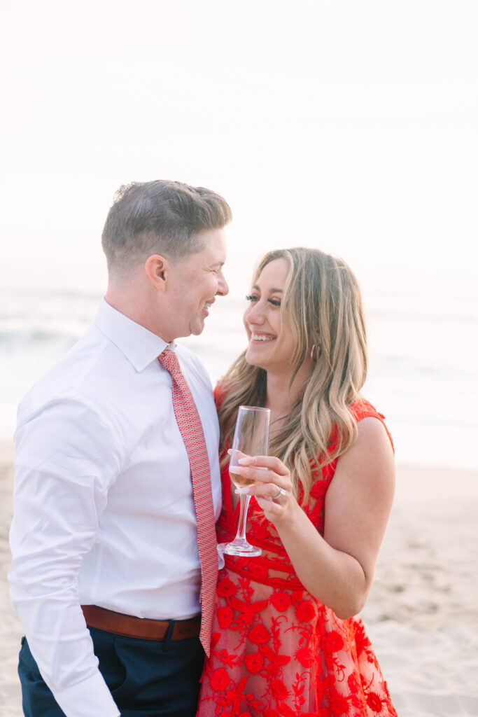 Bay Area wedding photographers capture couple celebrating recent proposal with champagne