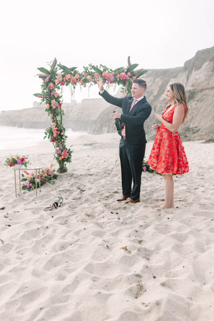 Bay Area wedding photographers capture man popping champagne after engagement