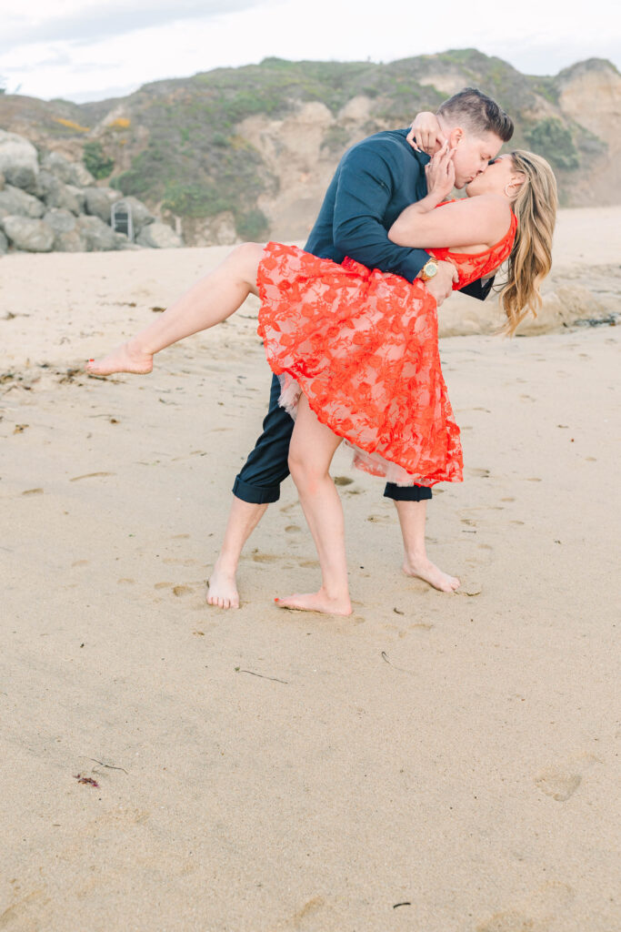 Bay Area wedding photographers capture couple kissing on beach after proposal