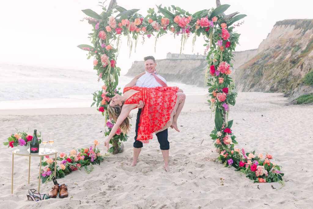 Bay Area wedding photographers capture man lifting woman up in celebration