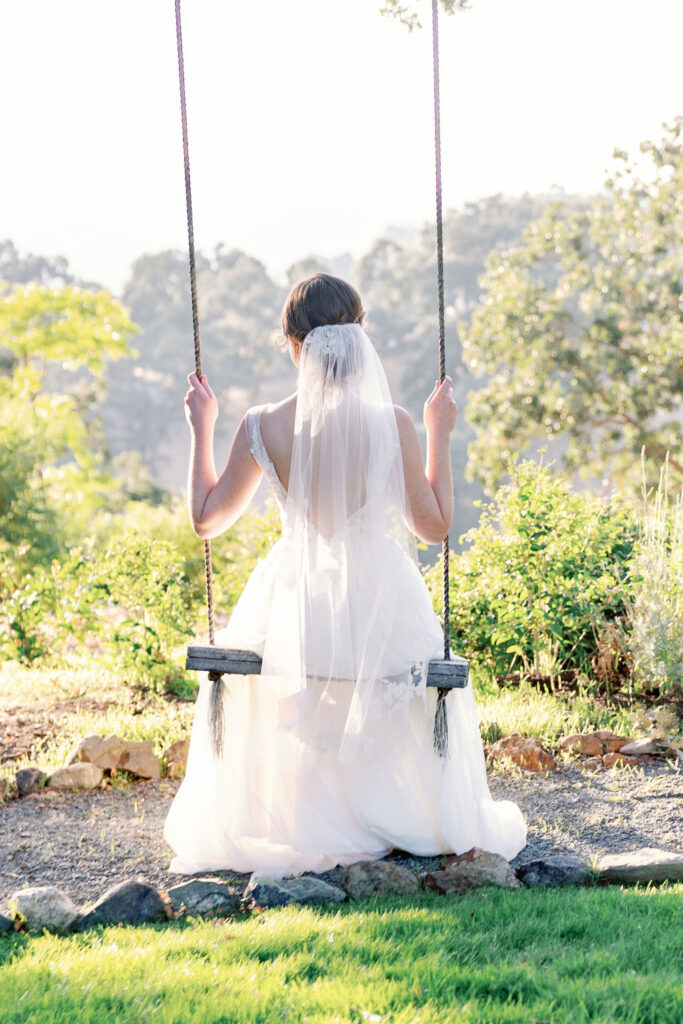 Bay Area wedding photographer captures bride sitting on swing after wedding