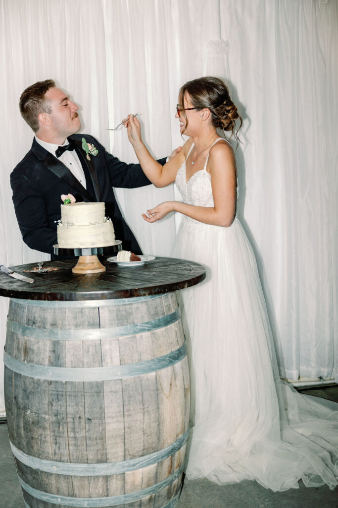 Bay Area wedding photographer captures couple feeding one another cake on wedding day