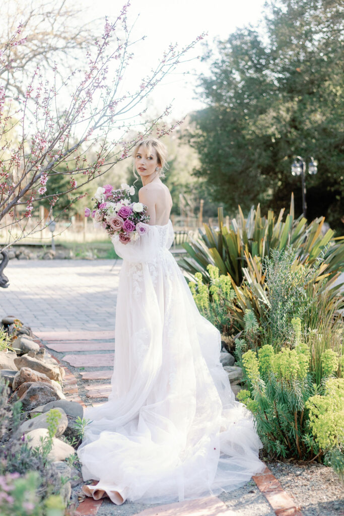 Bay Area photographer captures bride holding purple flower bouquet before California wedding