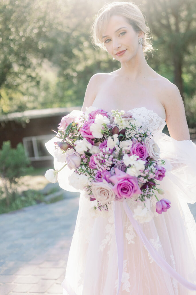 Bay Area wedding photographer captures bride wearing wedding dress holding purple bouquet