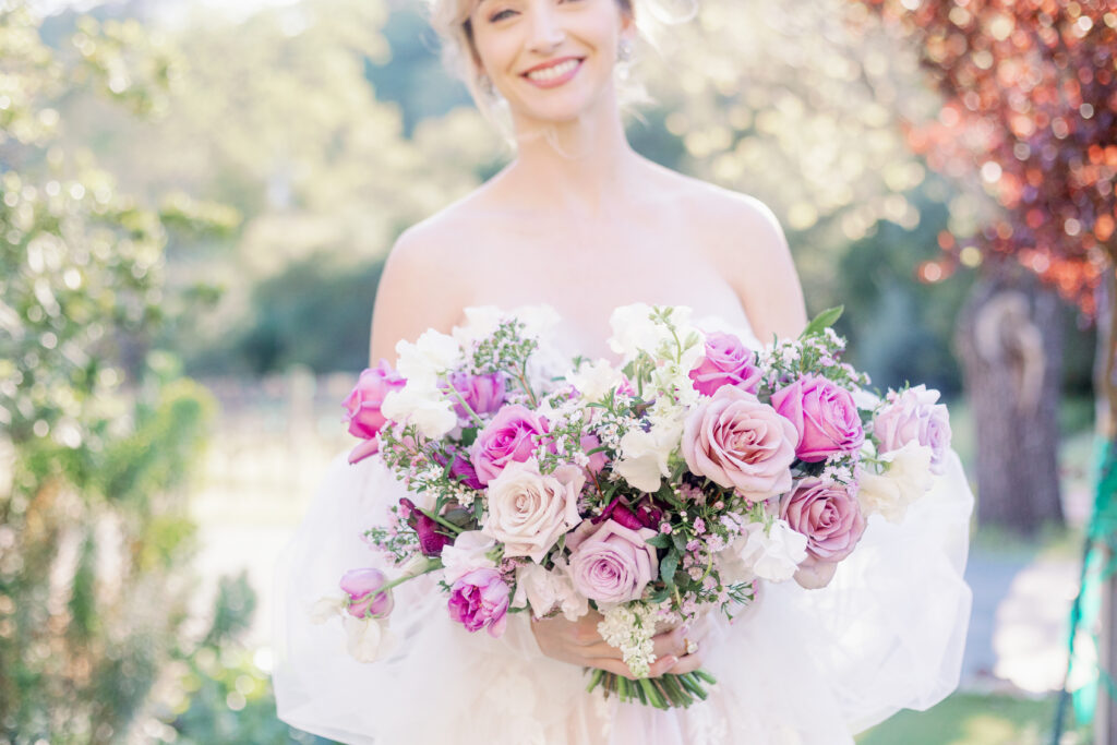 Bay Area wedding photographer captures bride holding purple bridal bouquet