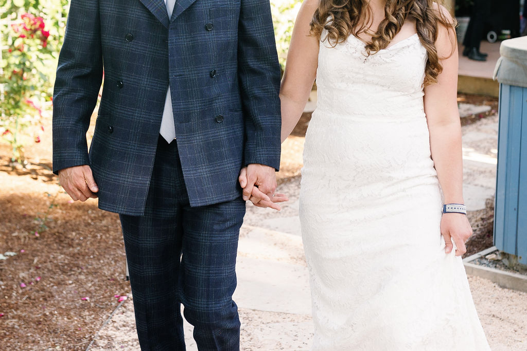 Bay Area wedding photographer captures bride and groom holding hands while walking