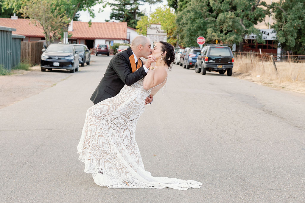 Bay Area photographer captures bride and groom kissing in street after California wedding