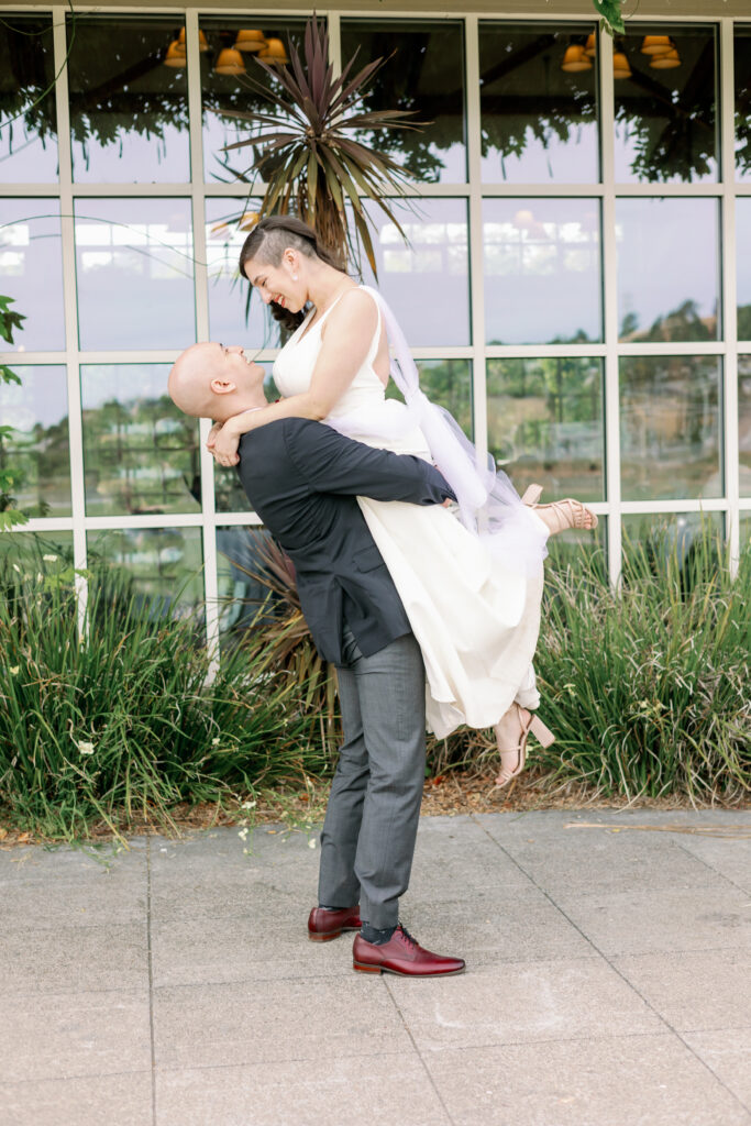 Bay area wedding photographer captures groom lifting bride
