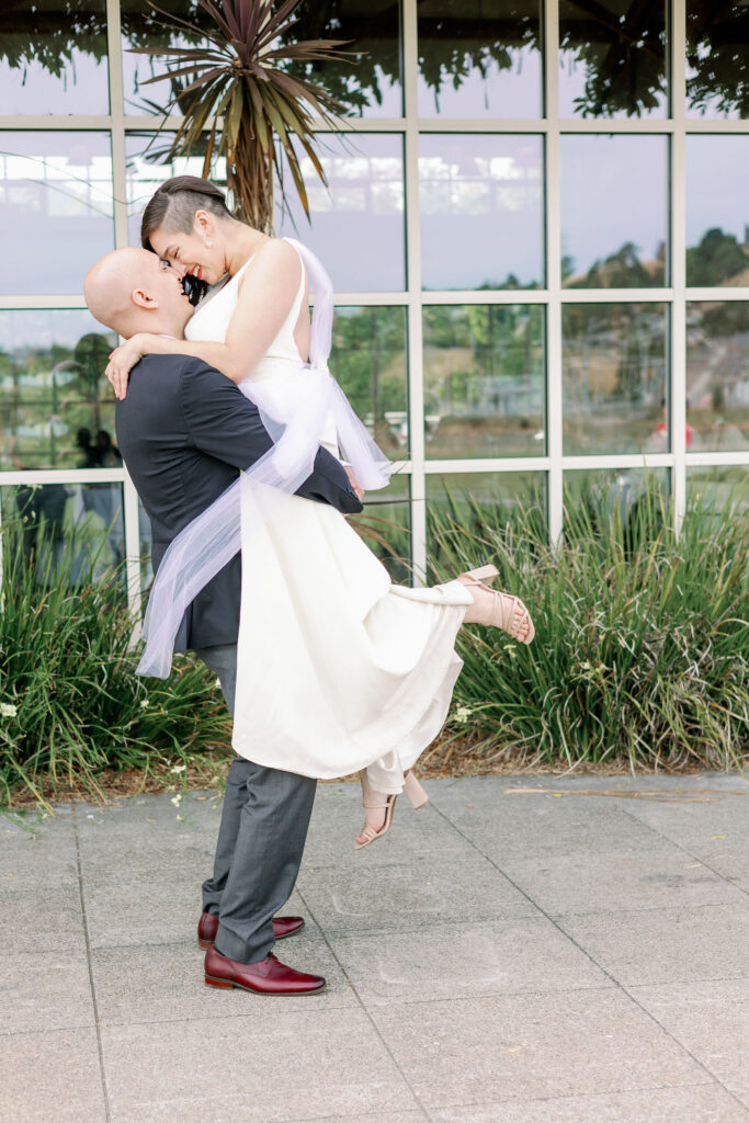 Bay Area photographer captures man lifting woman and kissing her during bridals