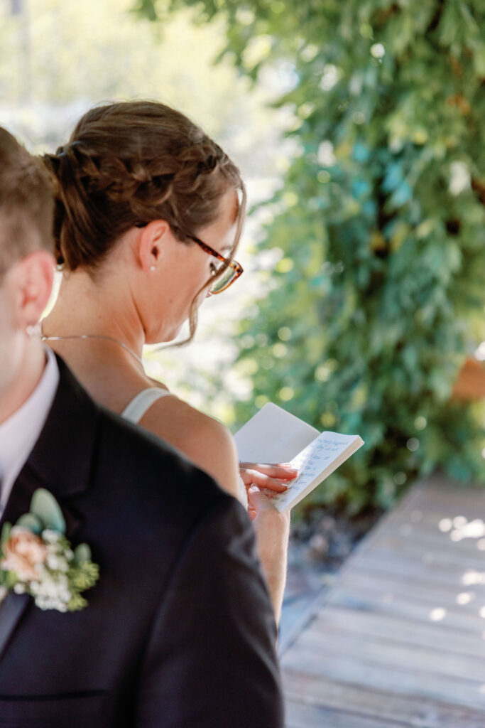 Bay Area wedding photographer captures bride holding and reading vow book