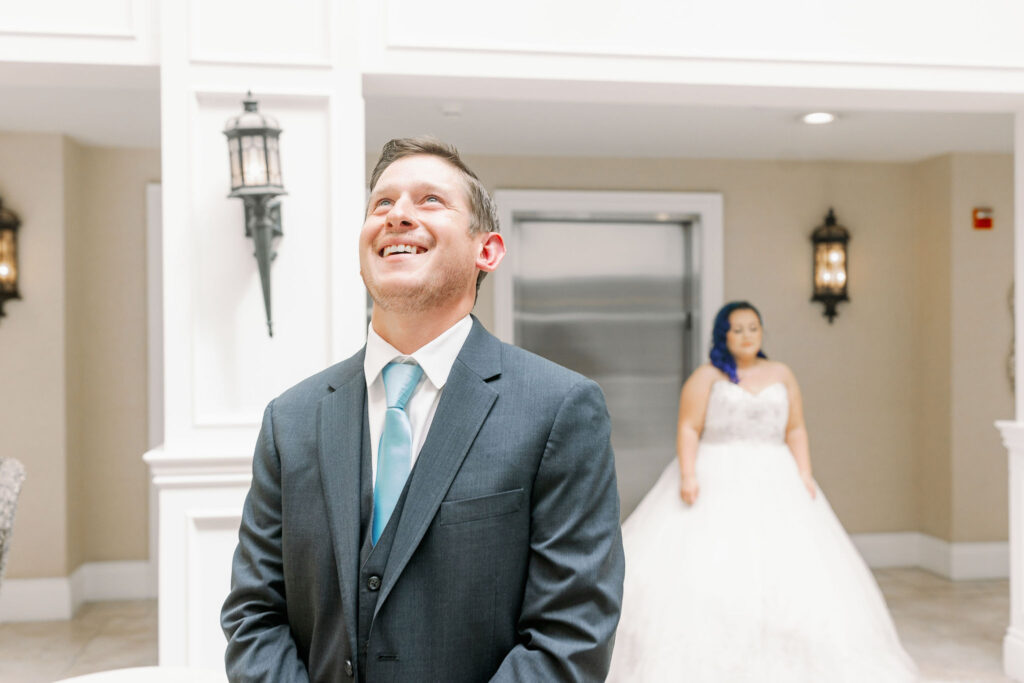 Bay Area photographers capture groom looking up and smiling before first look