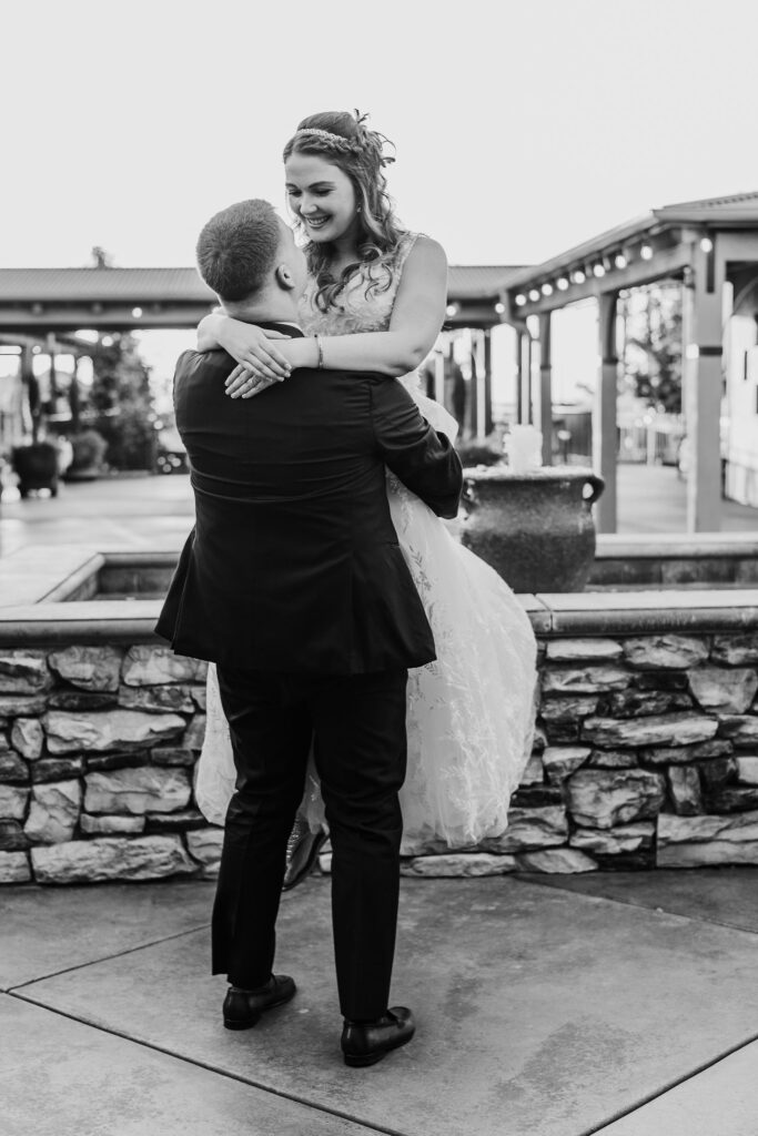 Bay Area photographer captures groom lifting bride in black and white portrait