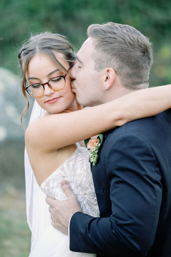 Bay Area photographer captures groom kissing bride's cheek 