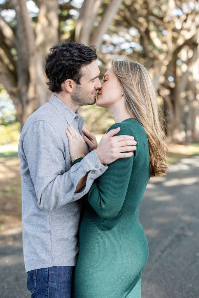 Bay Area wedding photographer captures man kissing woman wearing green dress