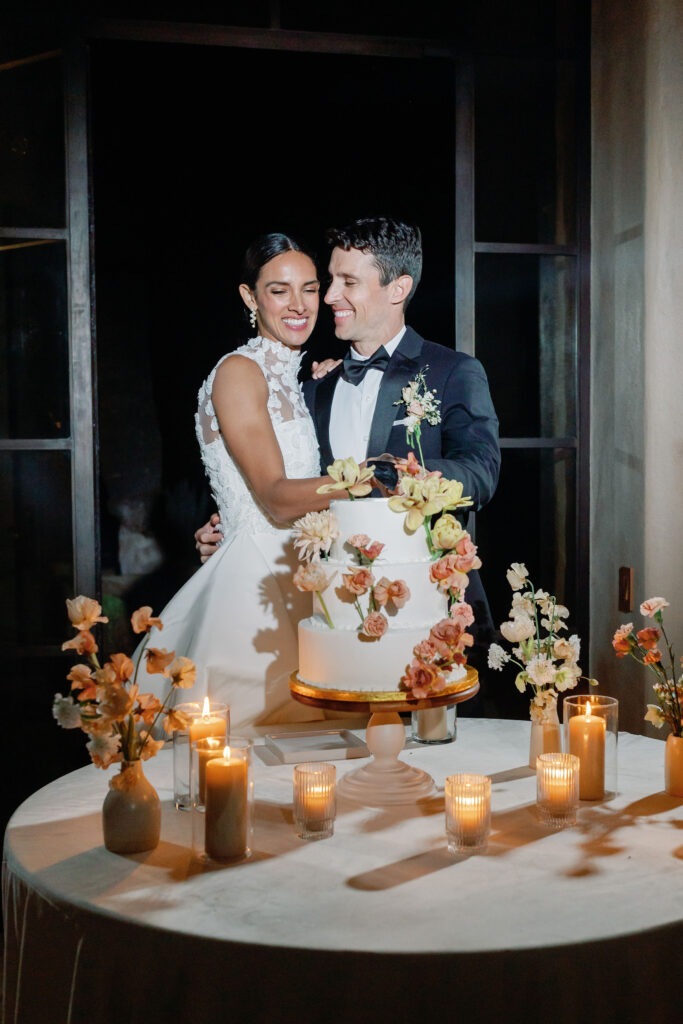 Bay Area wedding photographer captures bride and groom celebrating wedding with cake