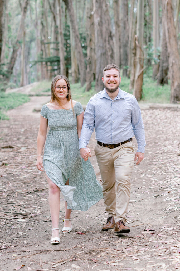 Bay Area wedding photographer captures couple walking hand in hand during outdoor engagements