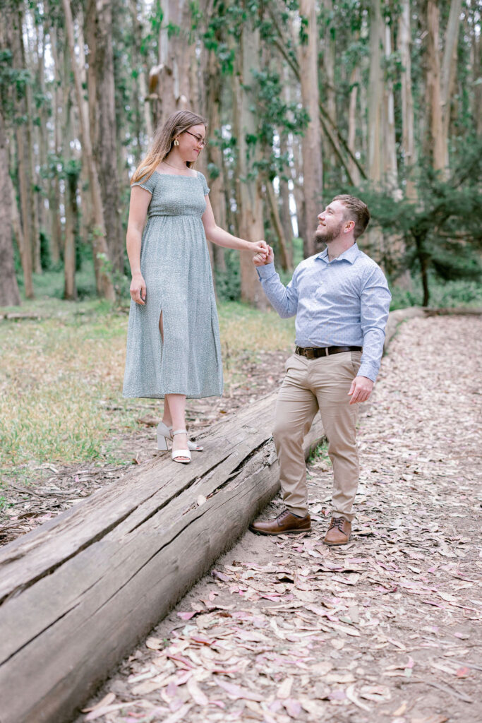 Bay Area wedding photographer captures woman on log as man holds her hand