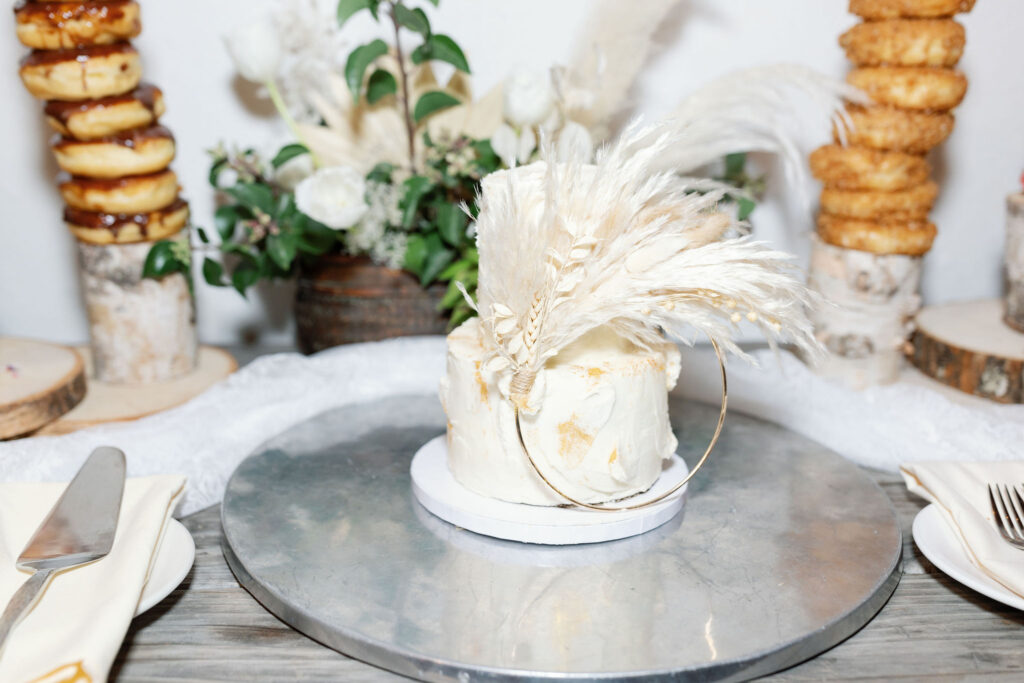 Bay Area wedding photographer captures wedding cake with pampas grass at best bakery in bay area