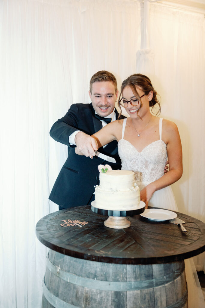 Bay Area wedding photographer captures bride and groom cutting wedding cake together