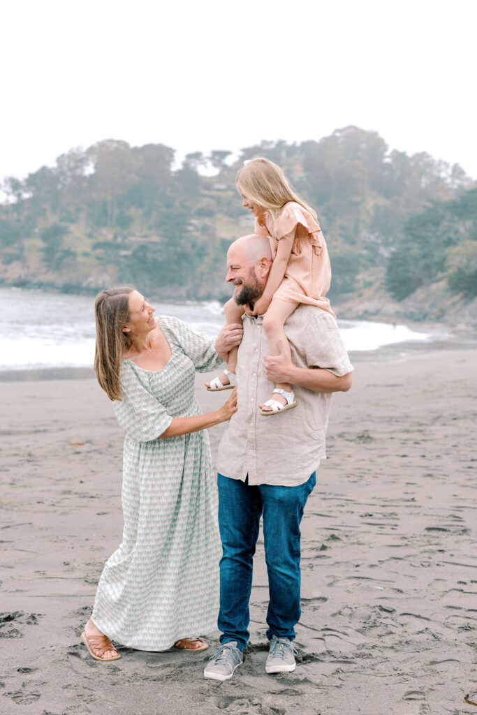 Bay Area wedding photographer captures father with child on shoulders and mother smiling