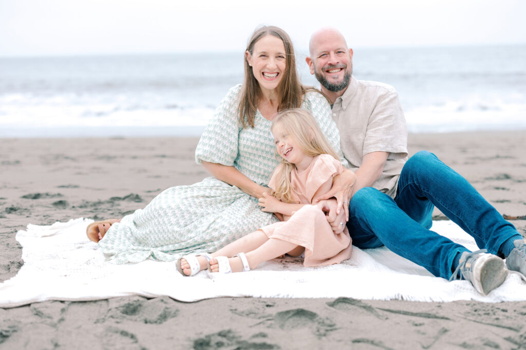Bay Area wedding photographer captures parents sitting on blanket with child
