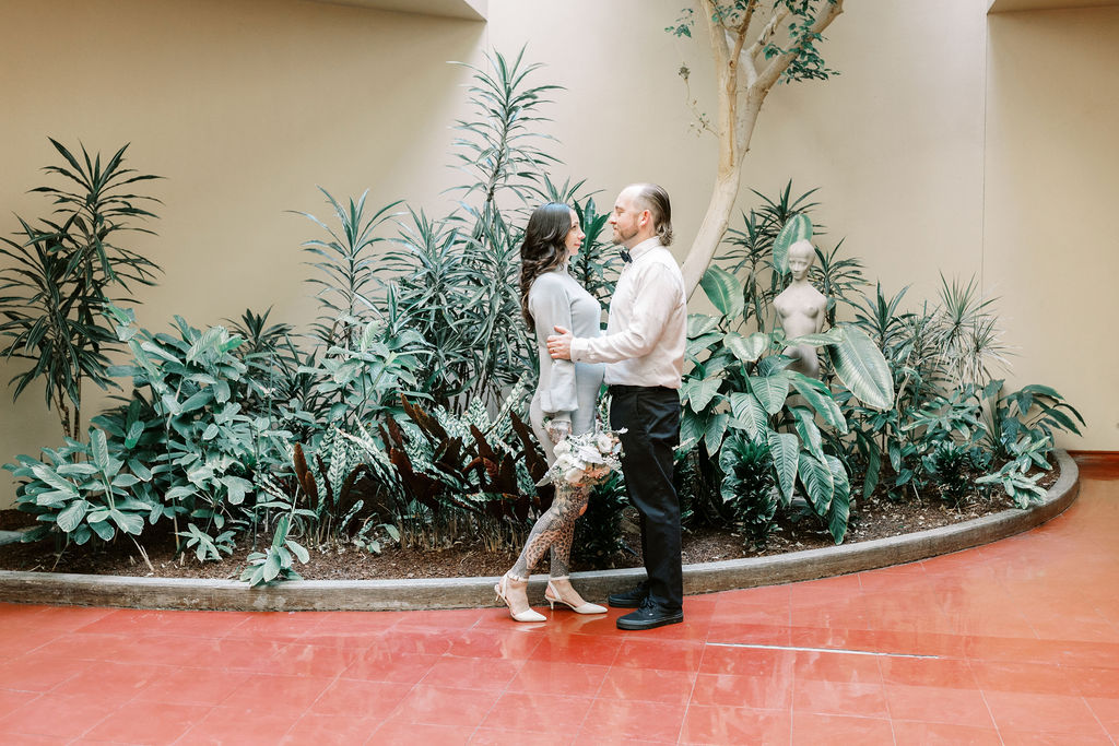 Bay Area wedding photographer captures couple embracing and looking at one another in the eye after Marin County Civic Center wedding