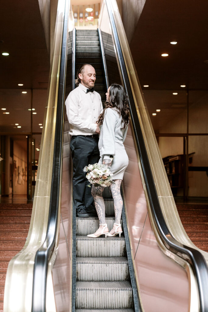 Bay Area wedding photographer captures bride and groom going up escalator together
