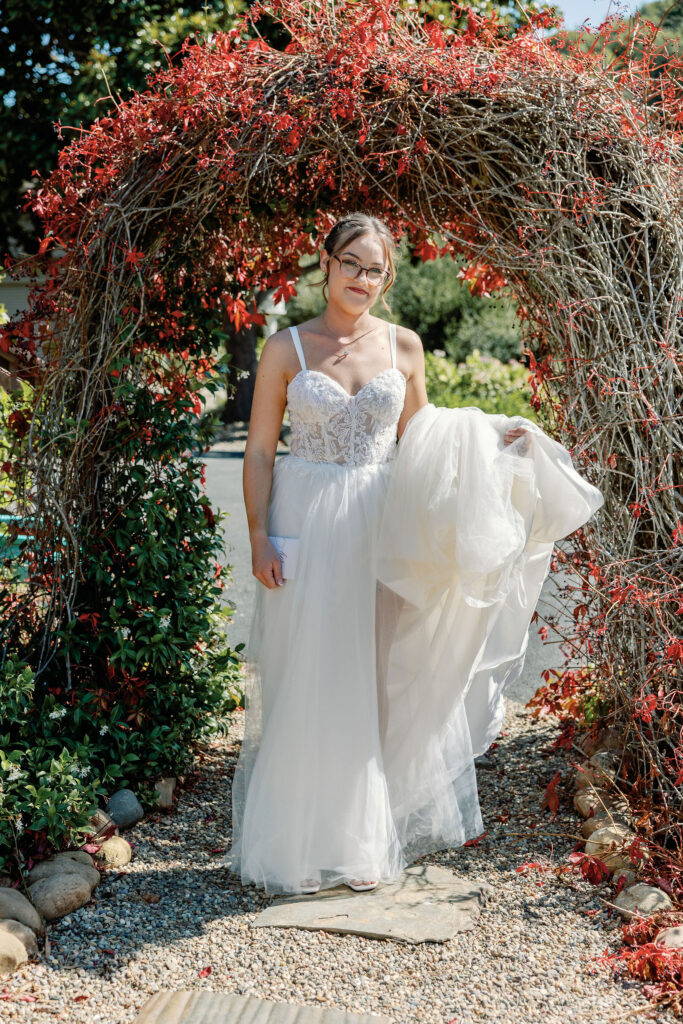Bay Area wedding photographer captures bride holding gown on wedding day