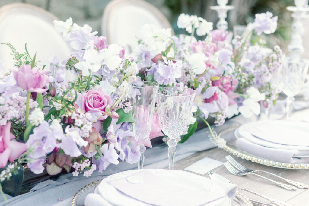 Bay Area wedding photographer captures pink and purple flowers in backyard wedding decor for table decor