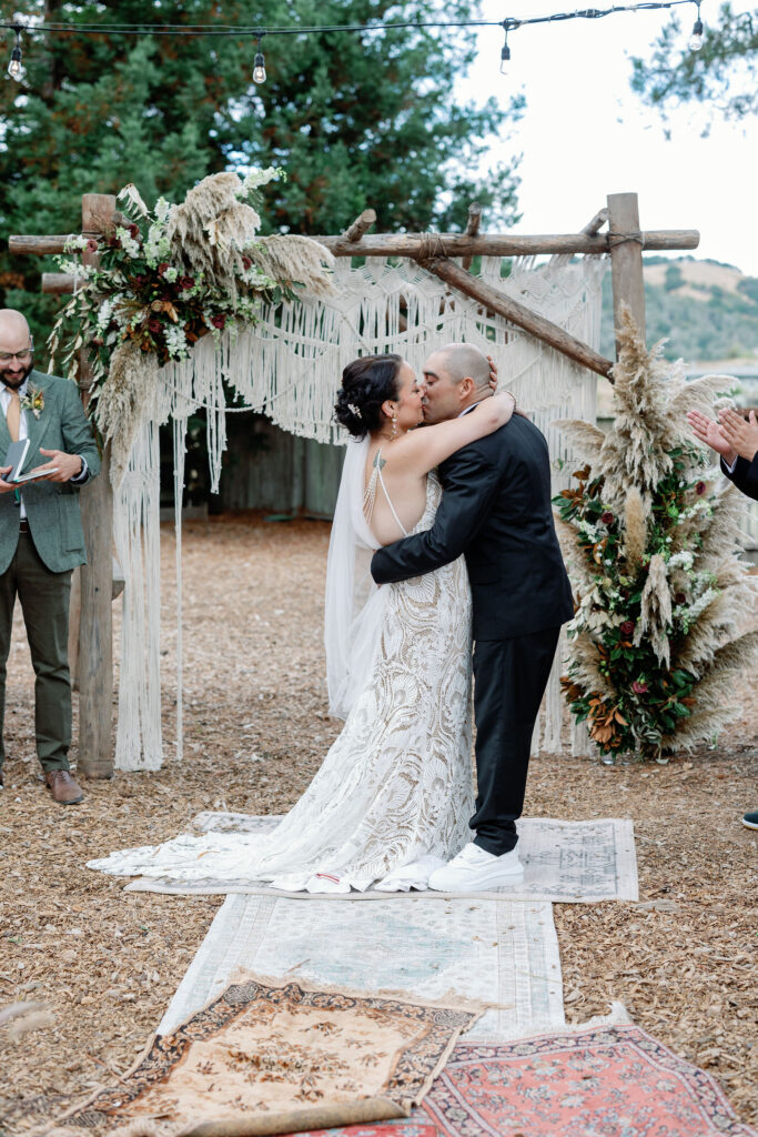 Bay Area wedding photographer captures bride and groom kiss after backyard wedding ceremony 