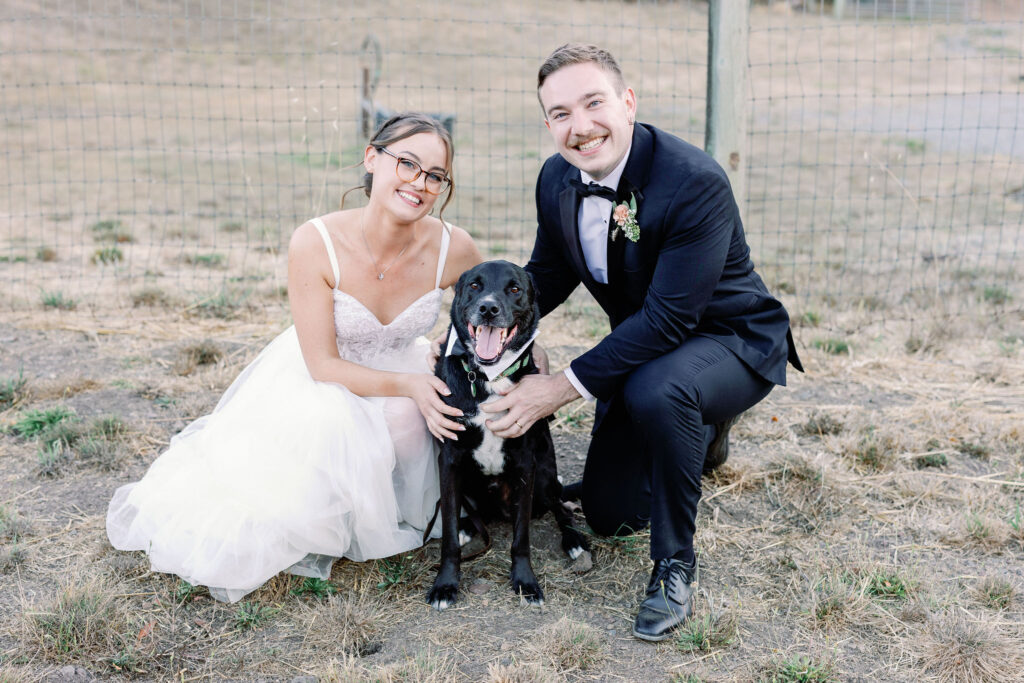 Bay Area wedding photographer captures bride and groom smiling with dog on wedding day