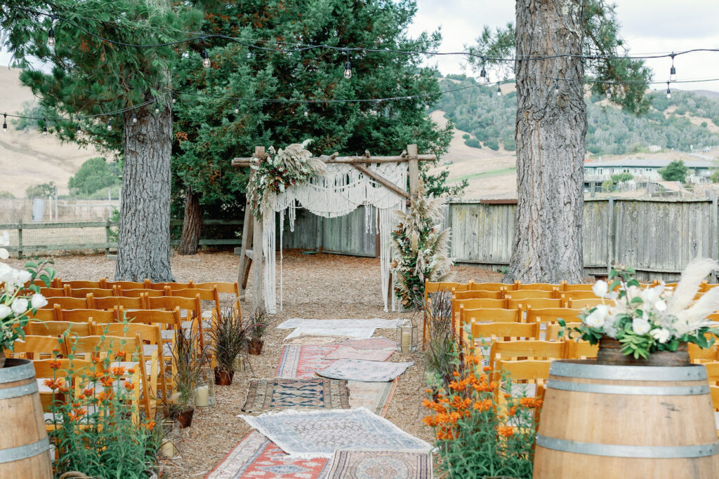 Bay Area wedding photographer captures boho wedding decor and arch at backyard wedding