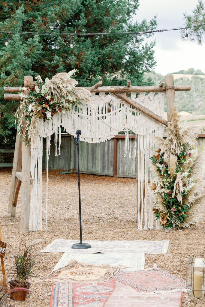 Bay Area wedding photographer captures boho wedding arch at backyard wedding