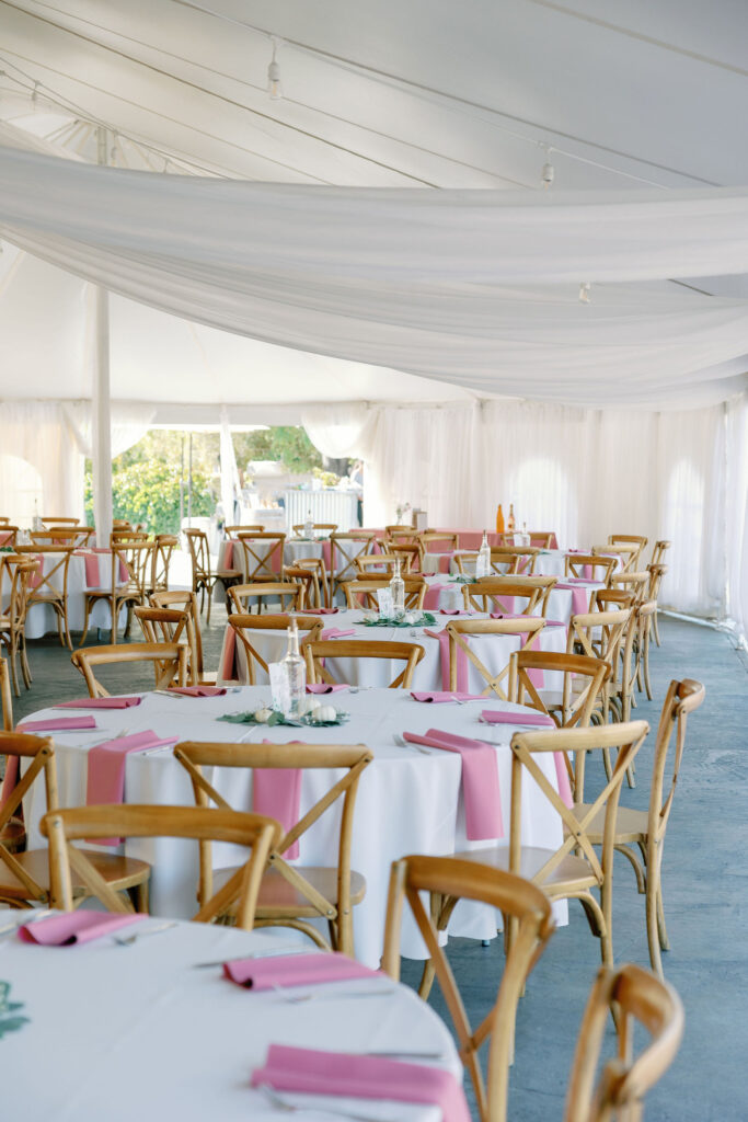 Bay Area wedding photographer captures tent reception with tables and chairs throughout