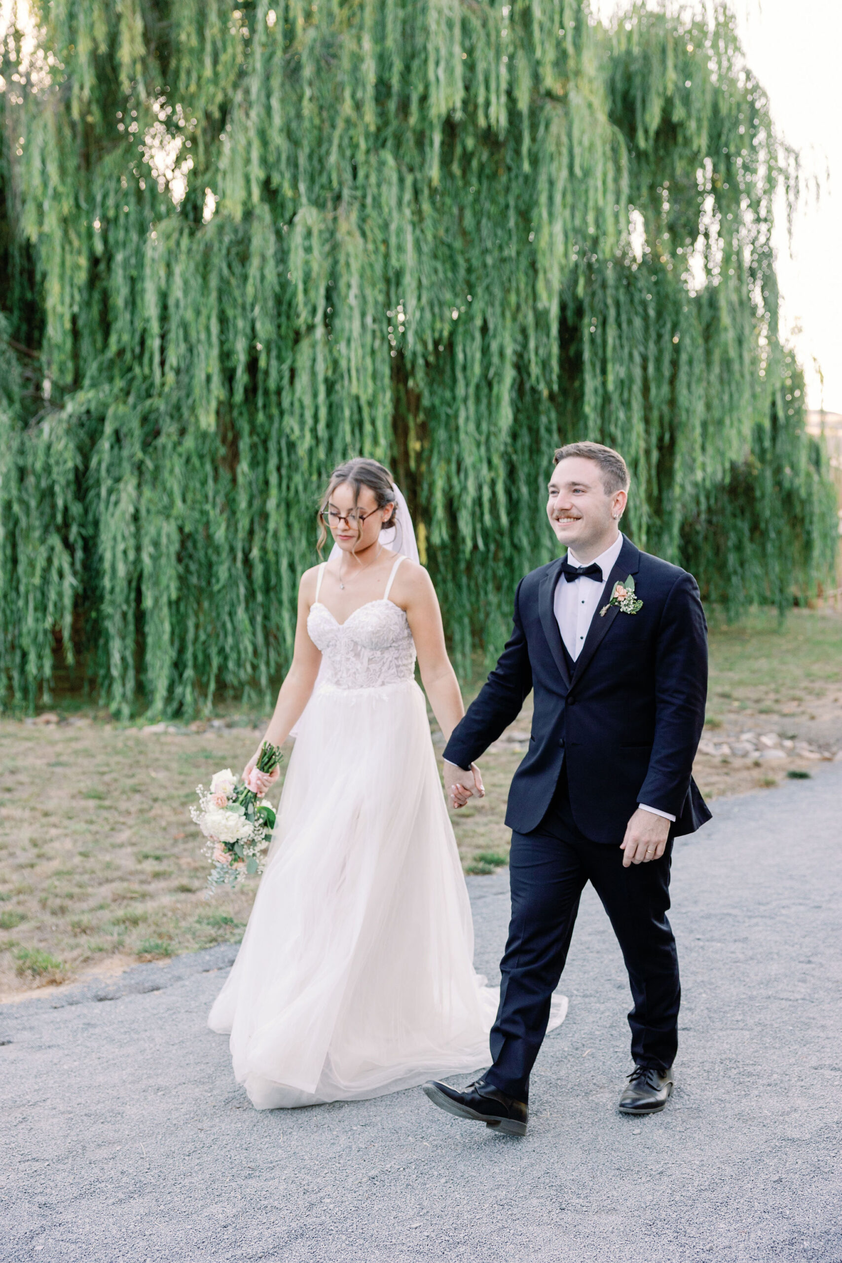 Bay Area wedding photographer captures bride and groom in wedding attire walking around Rosewood Events after wedding ceremony