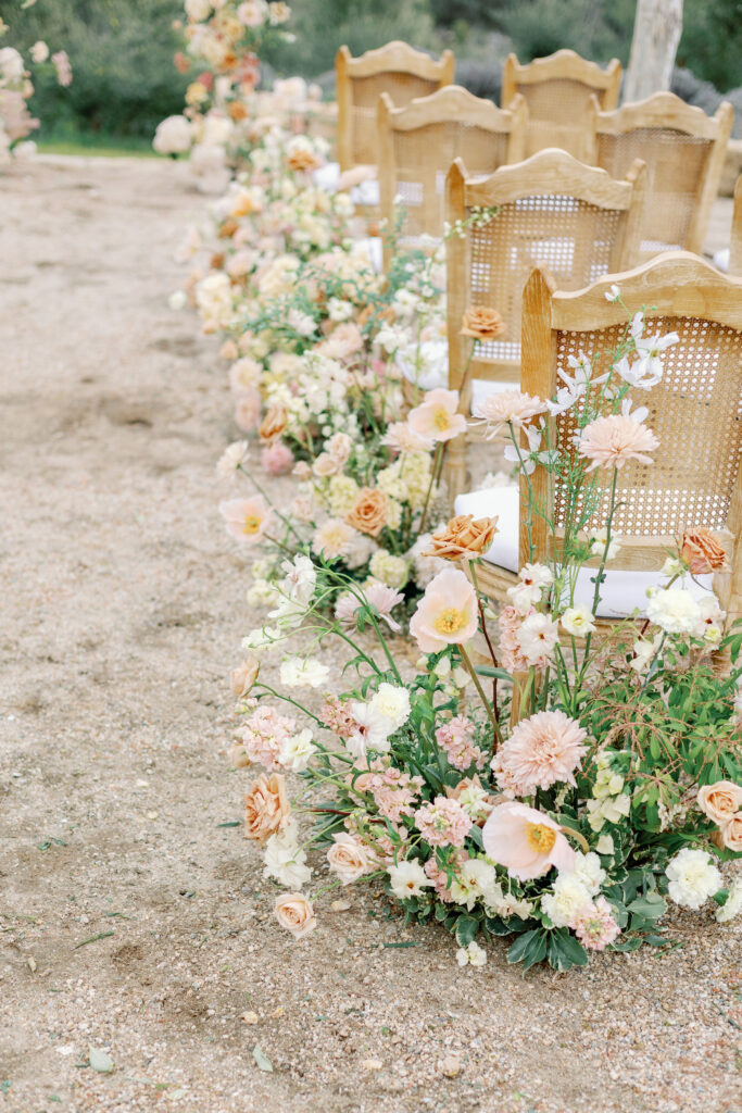 Bay Area wedding photographer captures wedding ceremony chairs with flowers surrounding the aisle