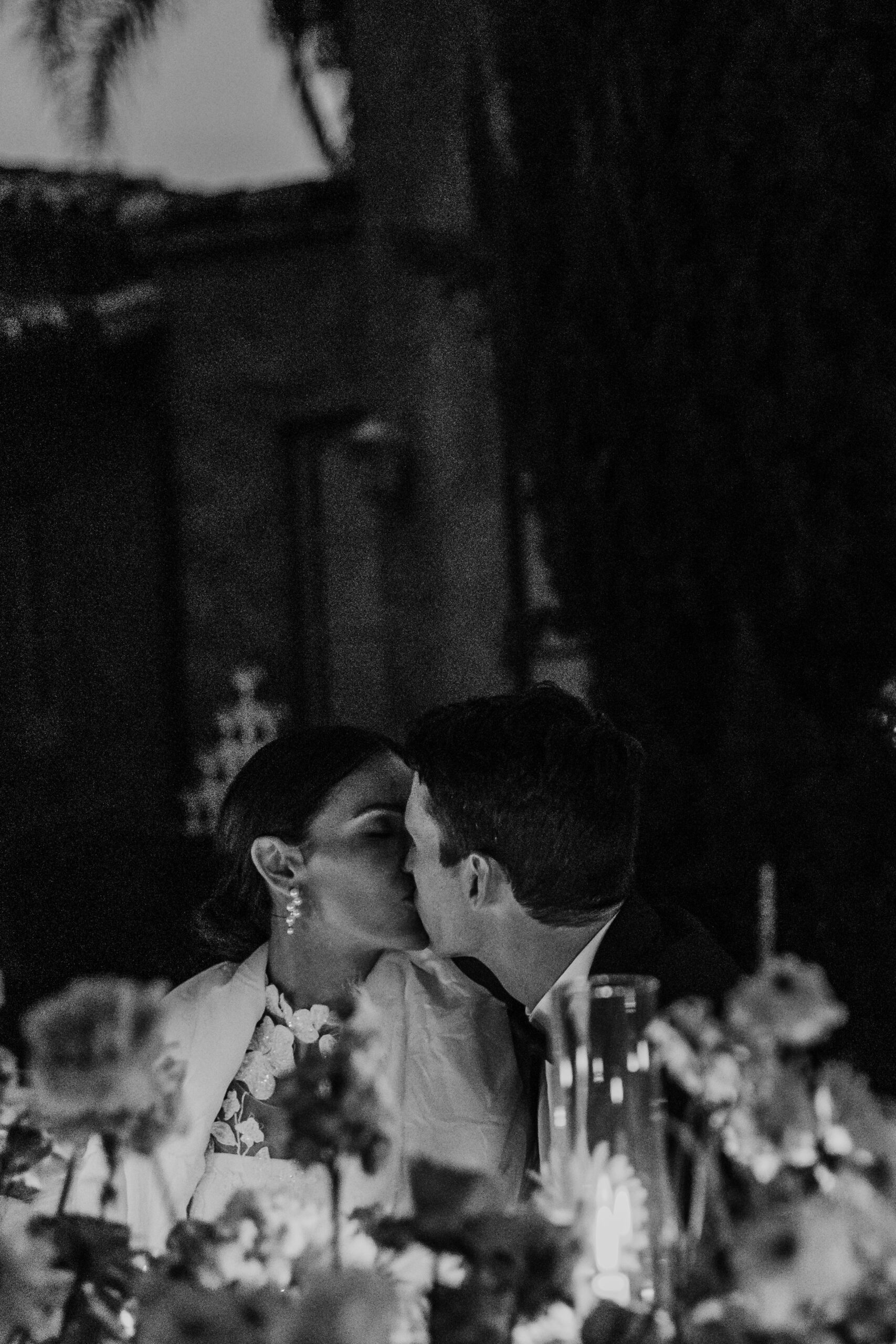 Bay Area wedding photographer captures bride and groom kissing at dinner reception