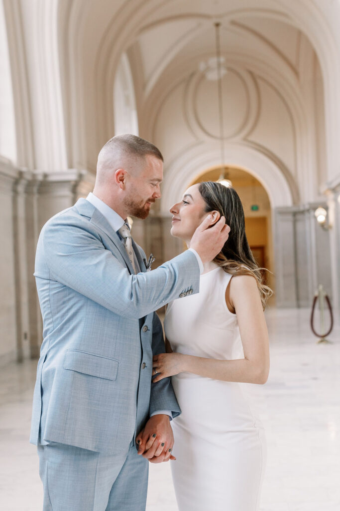 Bay Area wedding photographer captures groom touching bride's cheek