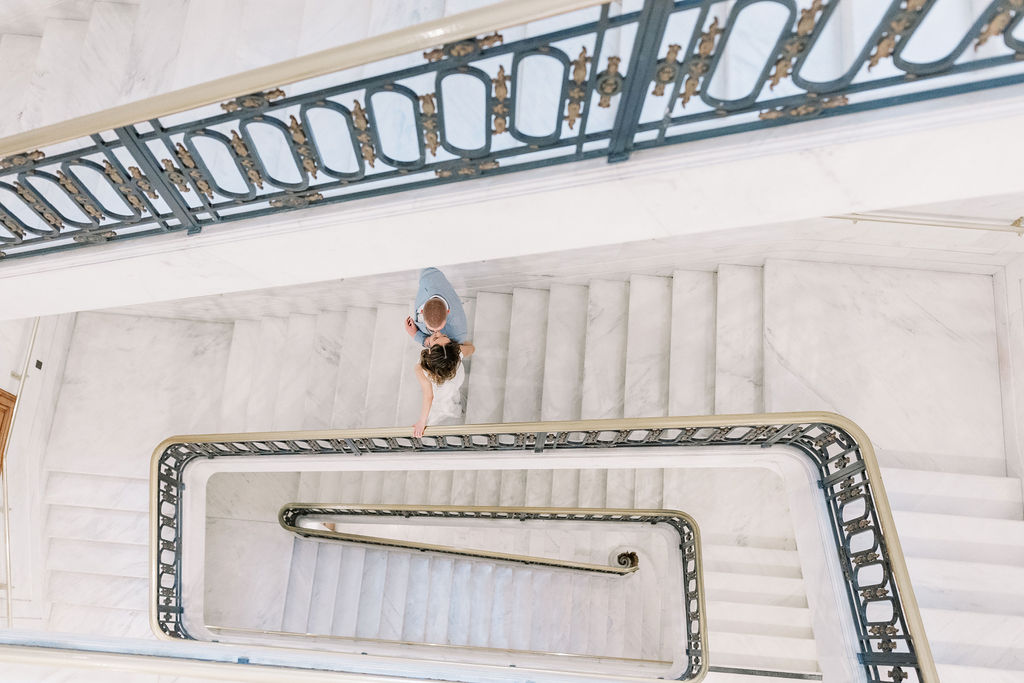Bay Area wedding photographer captures bride and groom walking down stairs after San Francisco wedding ceremony