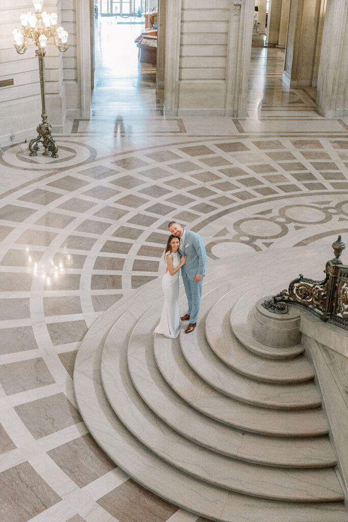 Bay Area wedding photographer captures bride and groom kissing in San Francisco City Hall