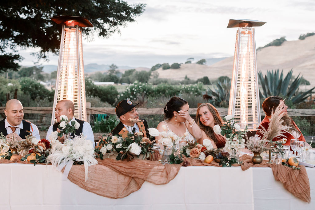 Bay Area wedding photographer captures bride and groom sitting at the dinner table