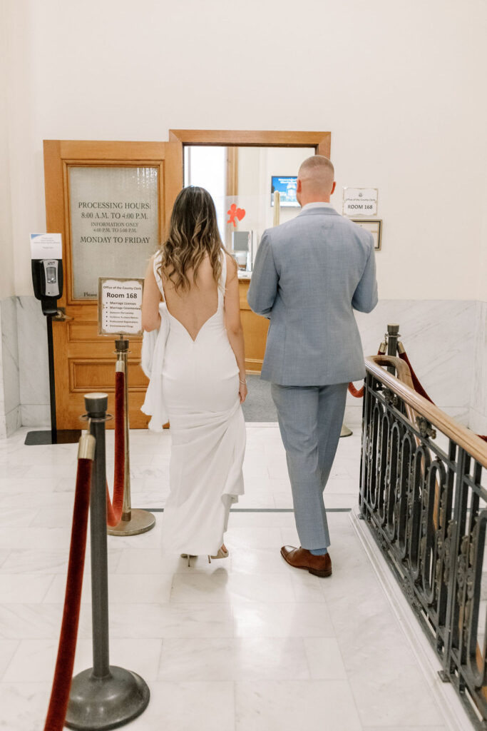 Bay Area wedding photographer captures bride and groom walking up to window